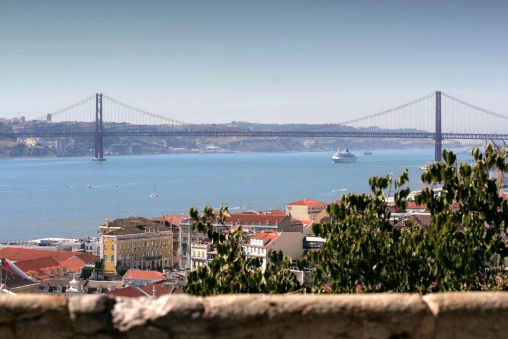 A city view of Lisbon with the river in the distance.
