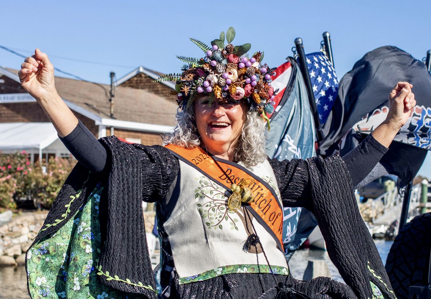 A jubilant Susan Clements celebrates after being named best witch at the 2022 witches parade in Wickford, R.I.