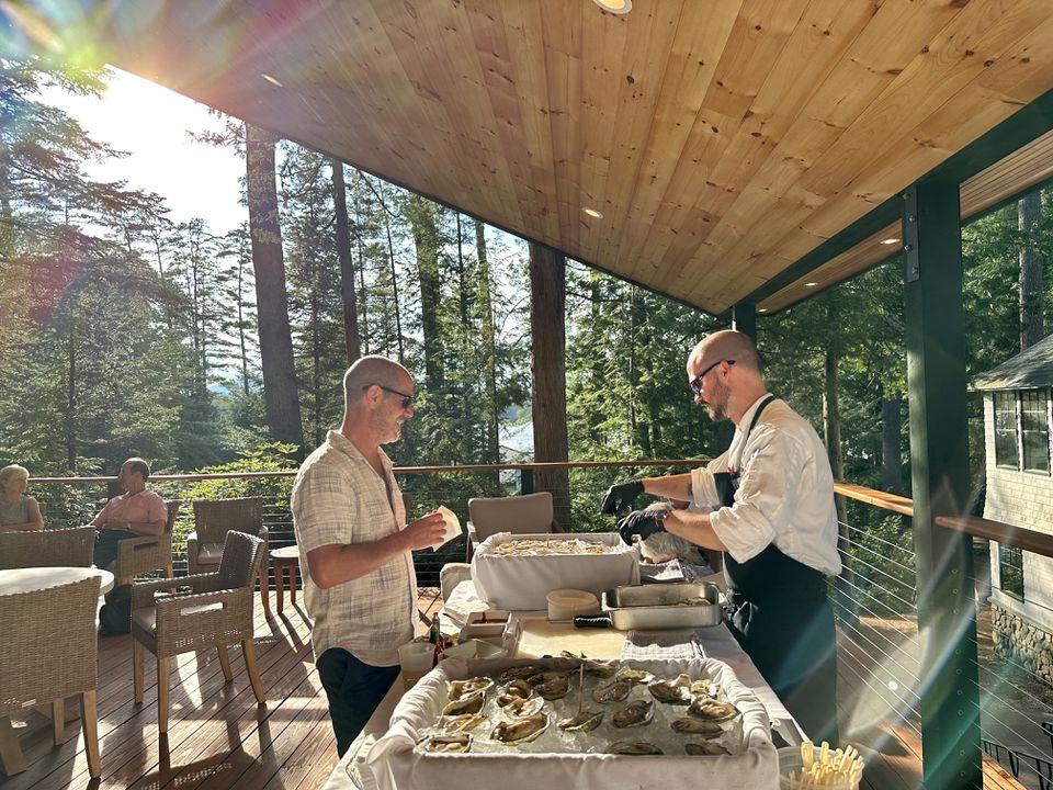 Chef Vogel shucks fresh Maine oysters on the newly renovated deck of the main lodge.